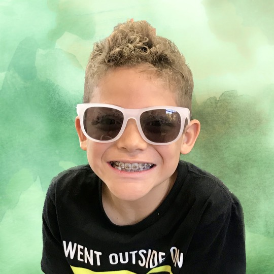 Happy kid with braces at Cool Smilez